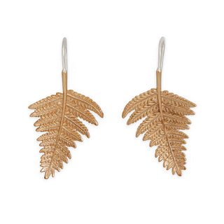 Bronze fern leaf-shaped earrings on a white background