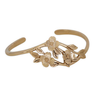 Bronze bracelet with floral design on a white background