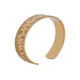 Bronze bracelet with intricate patterns on a white background