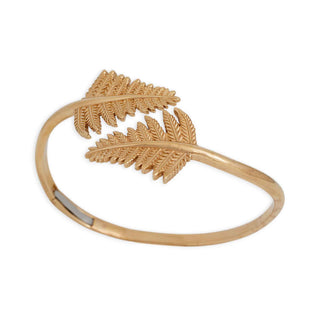 Bronze bracelet with fern leaf design on a white background