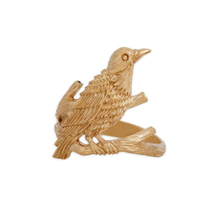 Gold bird-shaped ring on a white background