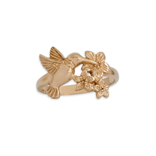 Gold ring with a hummingbird and floral design on a white background