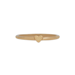 A minimalist gold ring featuring a small, polished heart-shaped charm set in the center, presented on a clean white background.