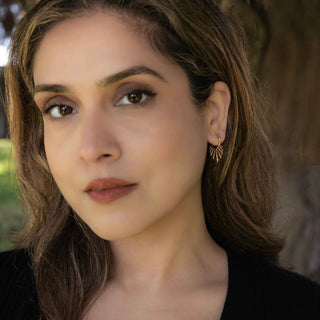 Close-up of a woman with a neutral expression outdoors