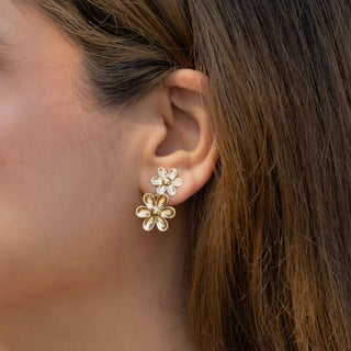 Close up of woman wearing double bronze daisy earrings