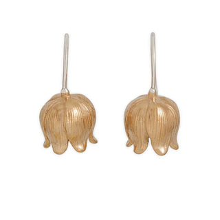Pair of bronze flower-shaped earrings on a white background