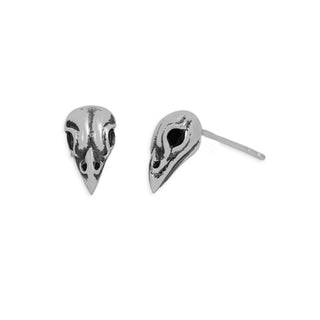 A pair of silver bird skull stud earrings, one shown from the front and the other from the side displaying the post, on a plain white background.