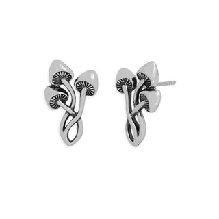 A pair of silver-toned mushroom stud earrings with textured, ribbed details on the underside of the caps, shown against a plain white background.