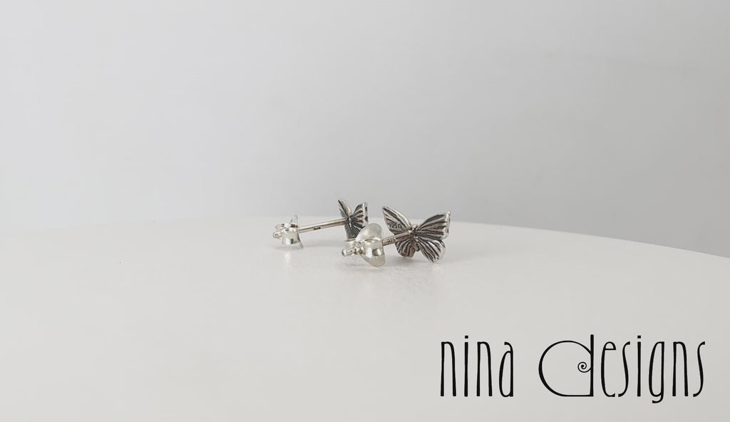 Turntable video of silver butterfly post earrings