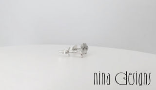 turntable video of sterling silver paw print post earrings