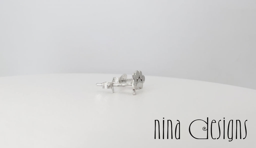 turntable video of sterling silver paw print post earrings