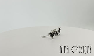 Turntable video of sterling silver mini bat post earrings