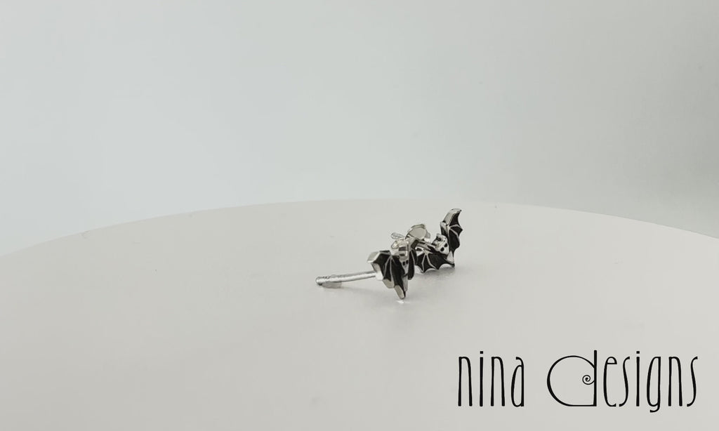 Turntable video of sterling silver mini bat post earrings